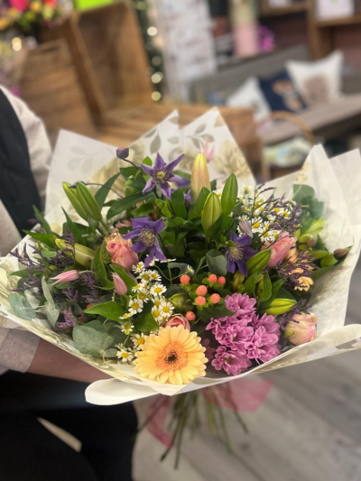 Country Garden Eco Wrap - A beautifully handcrafted eco hand-tied bouquet featuring a fresh selection of seasonal blooms in soft pastel tones.