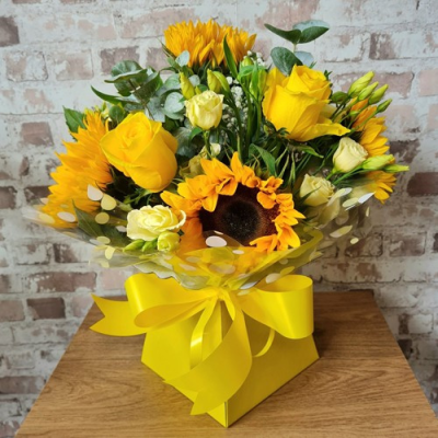 Smiles all Round Handtie - A gorgeous handtied bouquet, created using sunflowers, yellow roses and complimentary foliage.