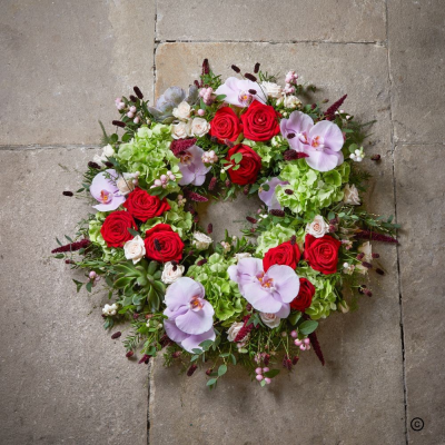 Red and Pink wreath - The loose wreath has a natural, effortless style, enhanced by exotic orchids and striking red roses.