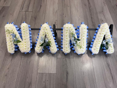 NANA Blue Letter Tribute - A beautifully handcrafted NANA funeral letter tribute, created with fresh white chrysanthemums and finished with coordinating blue ribbon and delicate floral sprays.