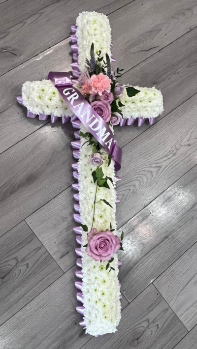 Purple Cross Tribute - A beautifully handcrafted floral cross funeral tribute featuring a fresh white chrysanthemum base.