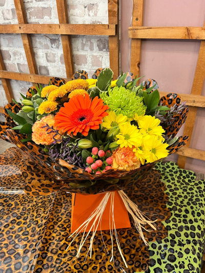 Zest for Life - A vibrant arrangement bursting with bold orange, yellow and fresh green tones, handcrafted by Daisy Chain Florist in Scunthorpe.