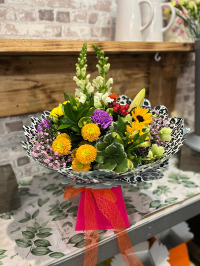 Bright Side - A fun and colourful arrangement bursting with bright yellow, orange, purple and pink tones, handcrafted by Daisy Chain Florist in Scunthorpe.