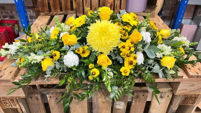Golden rememberance coffin spray - Bring a touch of warmth and comfort to a difficult day. Our Golden Remembrance coffin spray is beautifully handcrafted with a seasonal mix of yellow blooms that symbolize joy and c