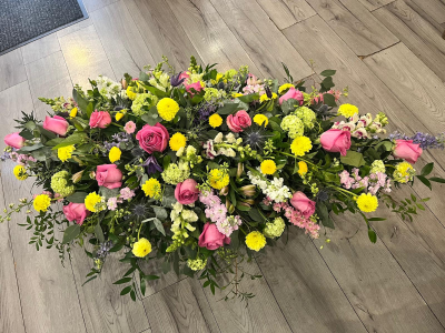 Springtime Coffin Spray - A beautiful, classic tribute honoring a life well lived. Our spring coffin spray is thoughtfully designed by our talented florists at Daisy Chain, using the season's finest,